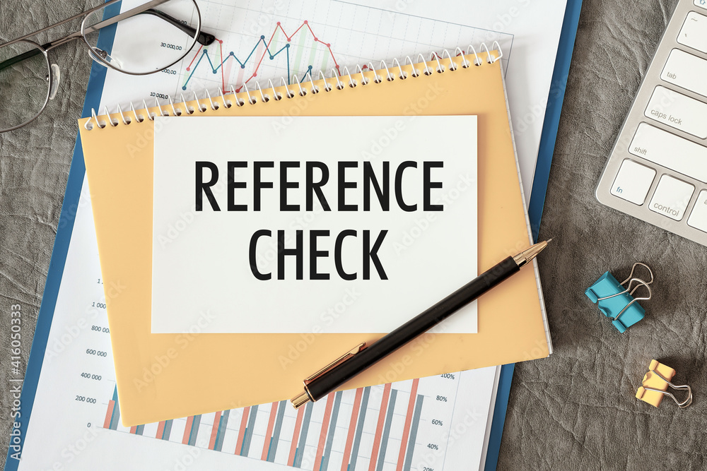 REFERENCE CHECK is written in a document on the office desk REFERENCE CHECK is written in a document on the office desk