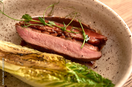 Soft focus. Entrecote Beef Grilled steak meat with fire flames on wooden cutting boardon with lattuce branch, pepper and salt . Master chef cooking delicious grill barbecue. photo