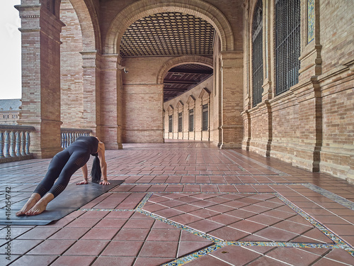 girl doing yoga in the Plaza de España in Seville