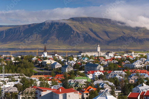 View from the Perlan of colourful houses, commercial buildings, churches and harbour of the city, with mountains beyond, Reykjavik, Iceland, Polar Regions photo