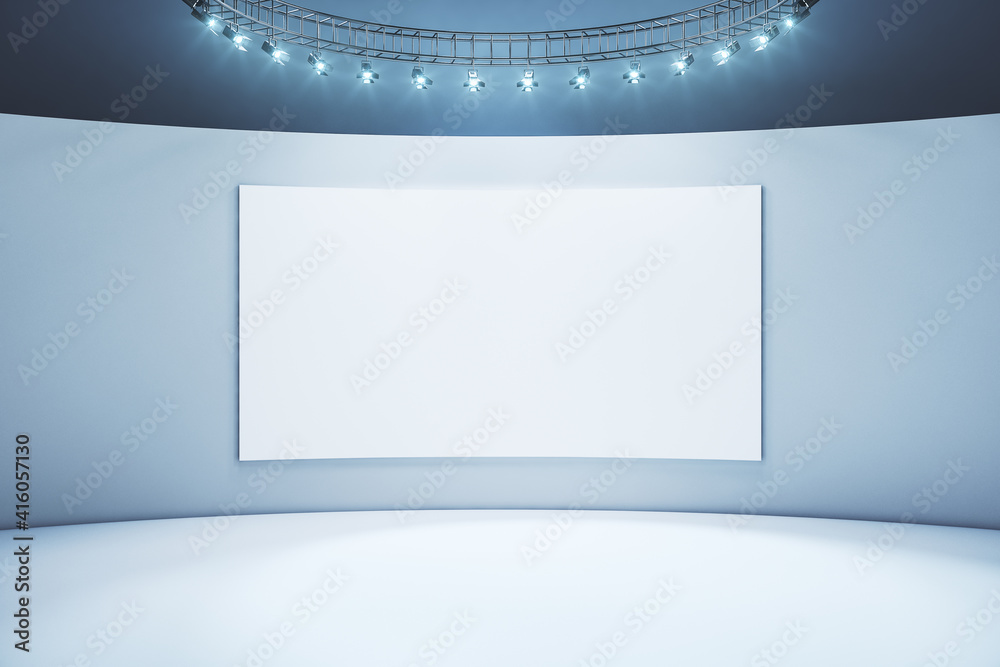 Blank white poster in the center of light wall in empty exposition room with led lights on top. Mockup