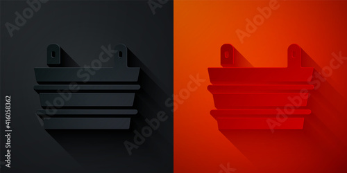 Paper cut Sauna bucket icon isolated on black and red background. Paper art style. Vector.