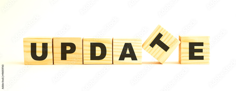 The word UPDATE . Wooden cubes with letters isolated on white background.