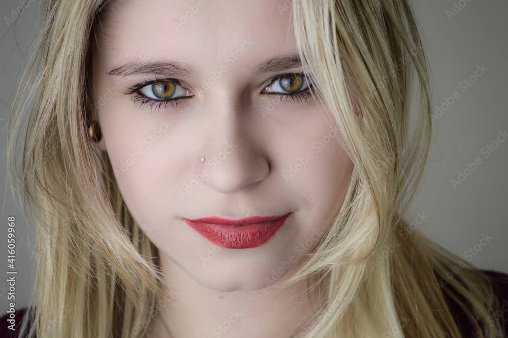 Portrait of a beautiful young blonde woman with red lipstick and intense gaze Portrait of a beautiful young blonde woman with red lipstick and intense gaze