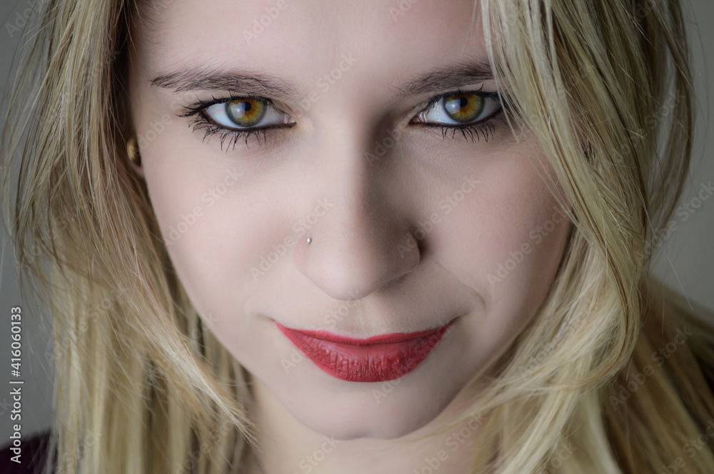 Portrait of a beautiful young blonde woman with red lipstick and intense gaze Portrait of a beautiful young blonde woman with red lipstick and intense gaze