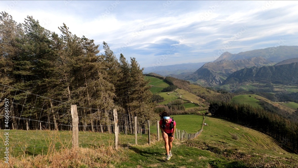 young woman trail running in the mountains young woman trail running in the mountains