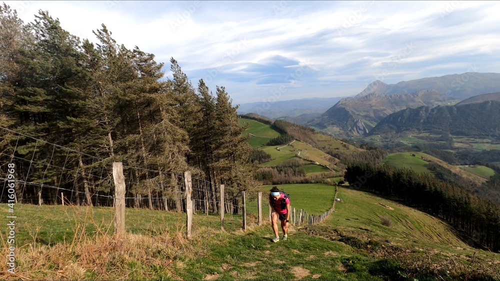young woman trail running in the mountains young woman trail running in the mountains