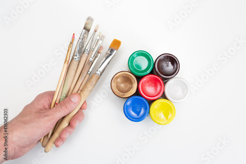 Brushes with colorful paints on a white background.