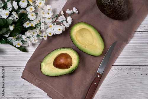 Avocado on old wooden table. Fruits healthy food concept.
