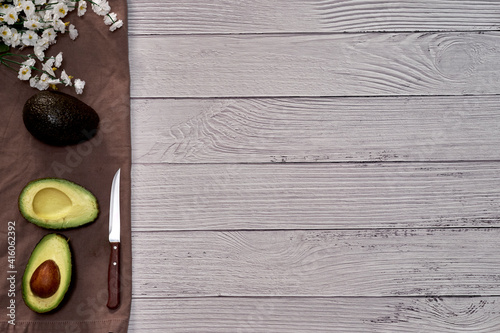 Avocado on old wooden table. Fruits healthy food concept.
