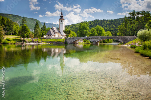 View of the Church of St. John the Baptist on the banks of the Sava river near Lake Bohinj in Slovenia