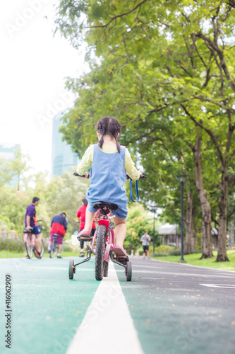 Wallpaper Mural Little girl with bike in city public park nature recreation Torontodigital.ca