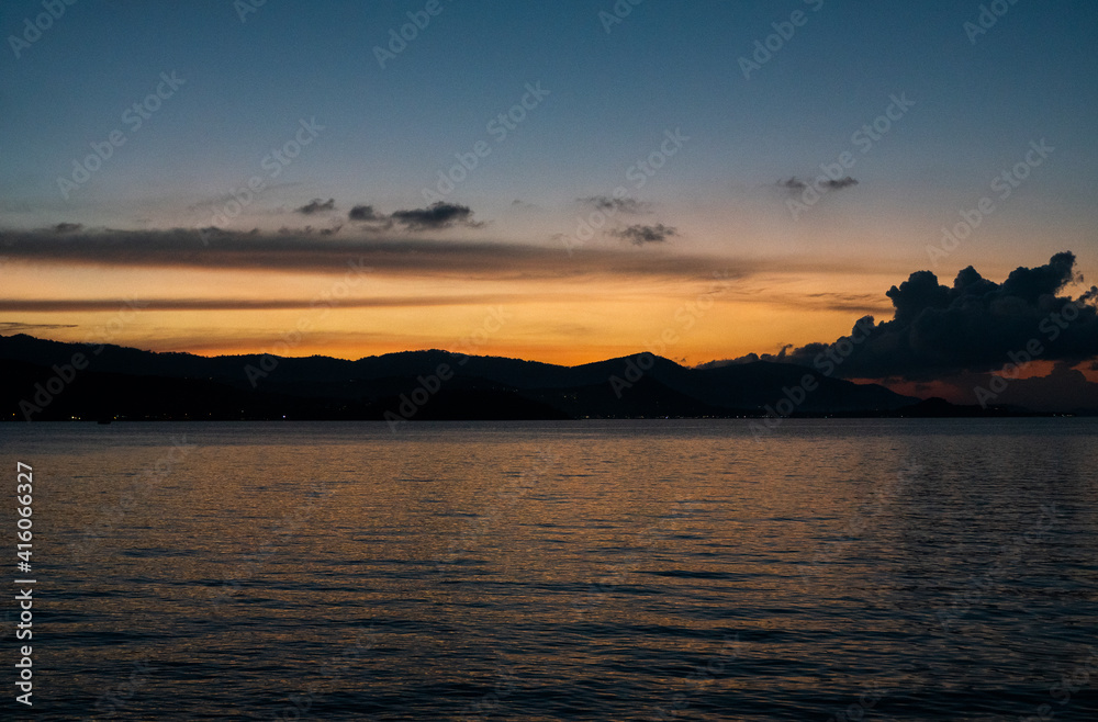 Sea view with sunset over the mountains.