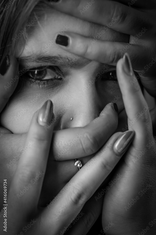 Black and white portrait of a young woman with her face covered with ...