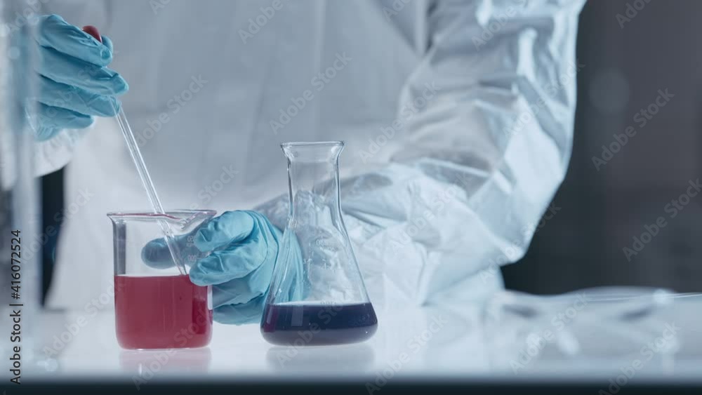 Scientist in laboratory working with test tubes and liquids Scientist in laboratory working with test tubes and liquids