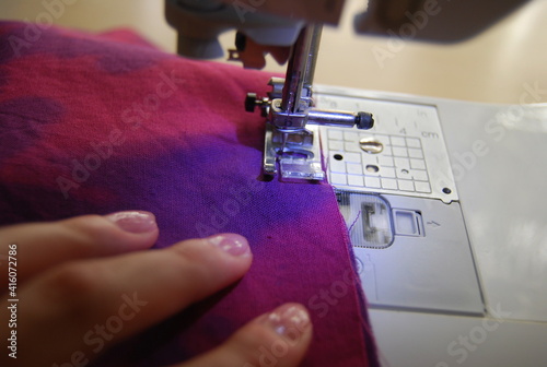 Sewing machine and women's hands
