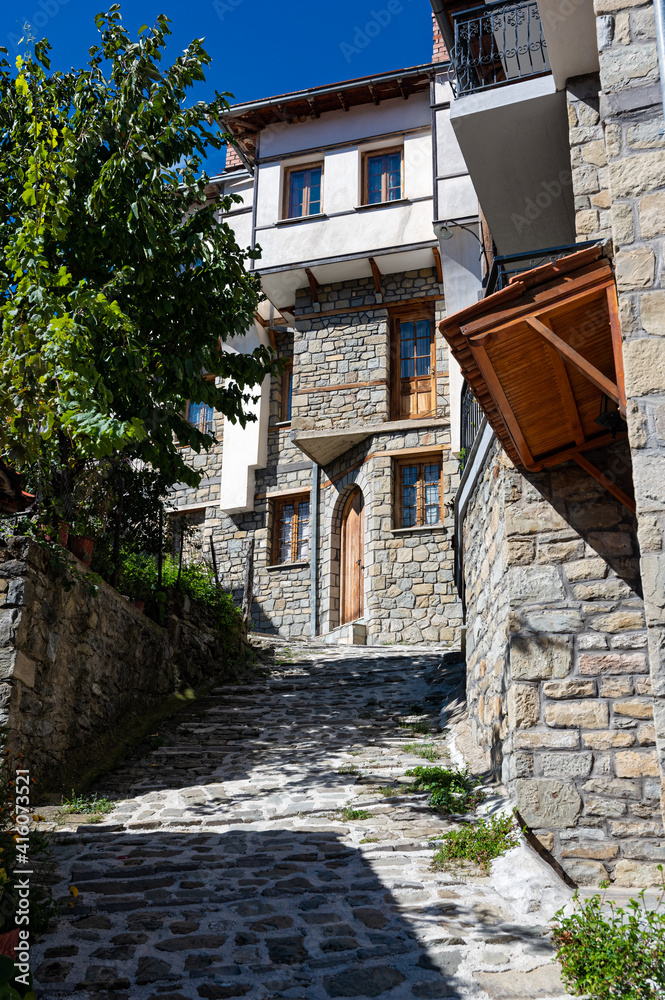 Stone houses of traditional architecture and cobble-stone narrow street in the town of Metsovo, Greece
