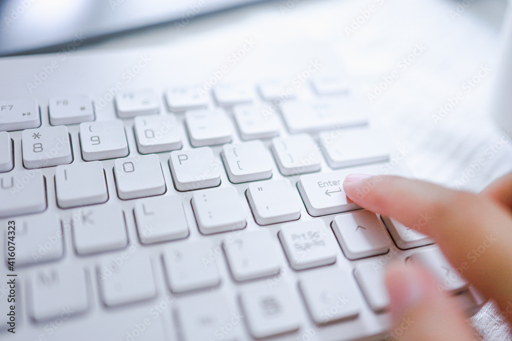 Hands of business woman Pressing enter button on computer keyboard Hands of business woman Pressing enter button on computer keyboard