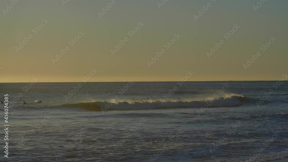 Surfers Riding Waves at Rodeo Beach in Sausalito California at Sunset Surfers Riding Waves at Rodeo Beach in Sausalito California at Sunset