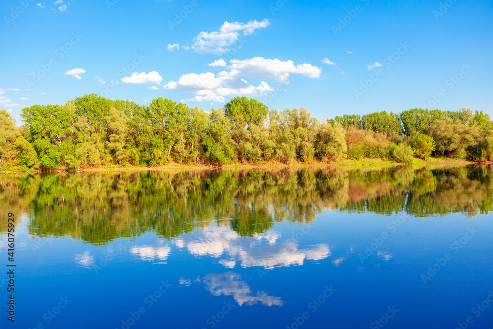 Nature reflection in the lake water. Majestic spring scenery 