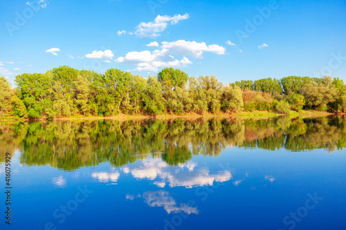 Nature reflection in the lake water. Majestic spring scenery 
