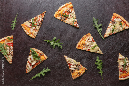 Slices of tasty pizza on dark background