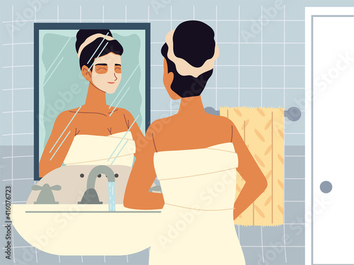 beautiful woman moisturizing face with cream or cleansing lotion in front of mirror, skincare