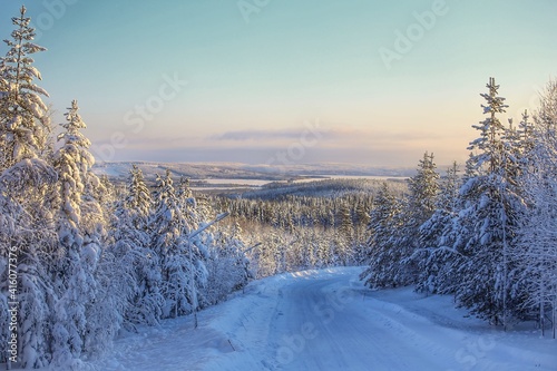 View over winter road to Lake Lillholmstrasket in Sweden, seen from Amliden photo