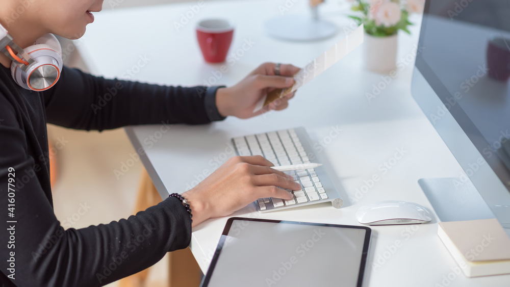 Close up of a man designer hand Selecting a color scheme and using the computer at the office. Close up of a man designer hand Selecting a color scheme and using the computer at the office.