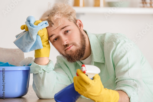 Tired young man with cleani...