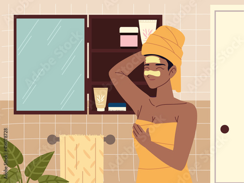 woman looking in mirror and applying skin care product