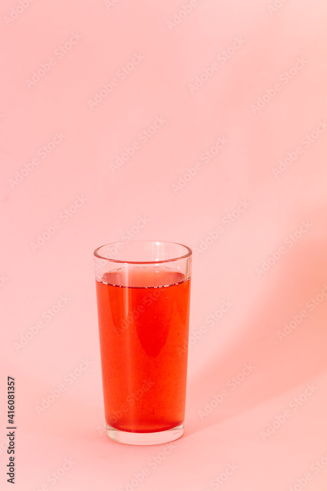 red berries juice on pink background, monochrome color
red berries juice on pink background, monochrome color