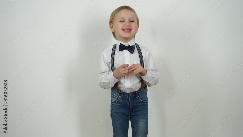 Joyful little boy. Dressed in jeans and a shirt on a white background. Emotion Video Series Joyful little boy. Dressed in jeans and a shirt on a white background. Emotion Video Series