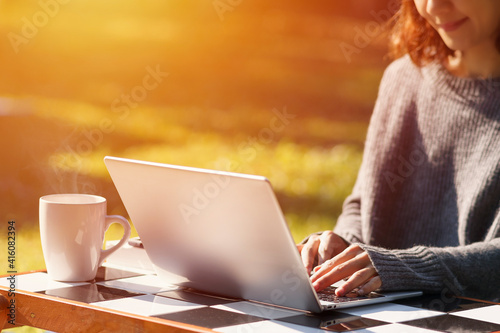 Young girl using laptop in the garden