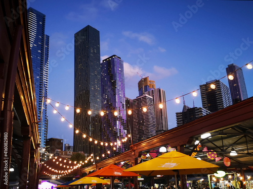 Melbourne's famous Summer Night Market selling only ethnic food and drink - every Wednesday at Victoria Market. Melbourne Cityscape background.