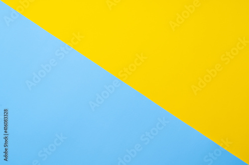 Yellow-blue background bisected vertically. Diagonal blue and yellow sheet of paper