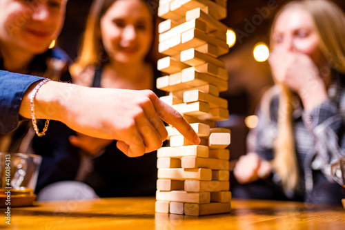 Young people have fun playing board games at a table .