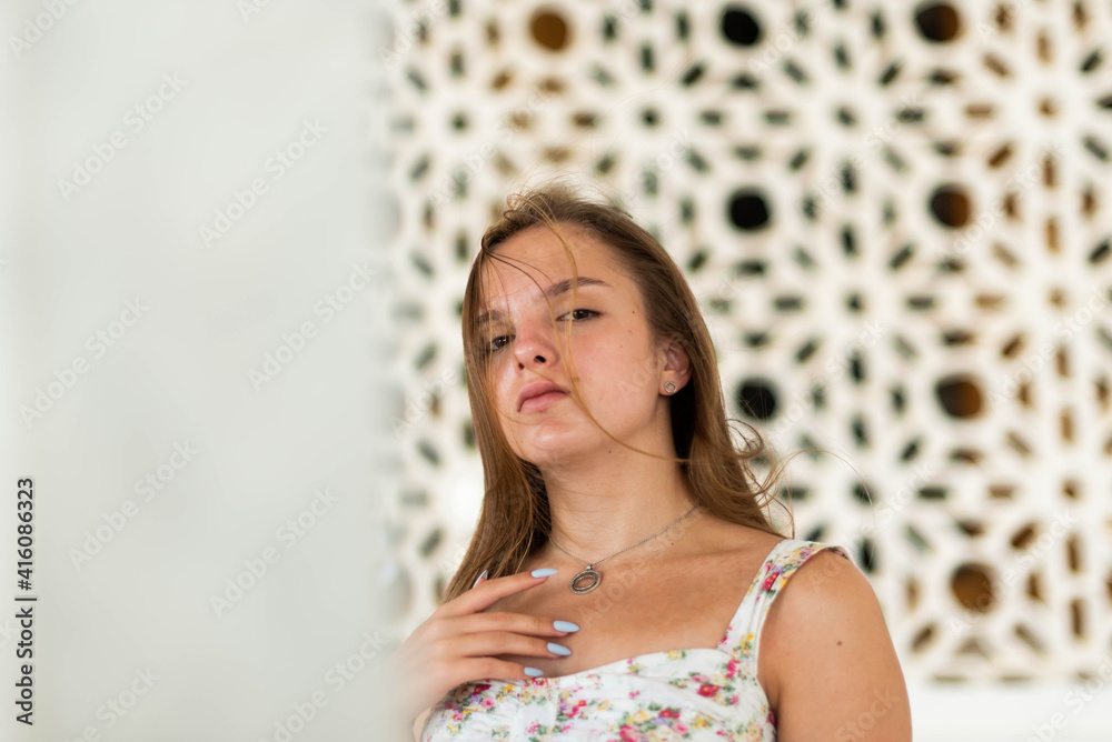 Beauty Sunshine Girl Portrait. Happy Woman Smiling and looking Down. Sunny Summer Day under the white wall. Beauty Sunshine Girl Portrait. Happy Woman Smiling and looking Down. Sunny Summer Day under the white wall.