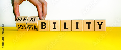 Flexibility and adaptability symbol. Businessman turns wooden cubes and changes words adaptability to flexibility Beautiful white background, copy space. Business, flexibility and adaptability concept