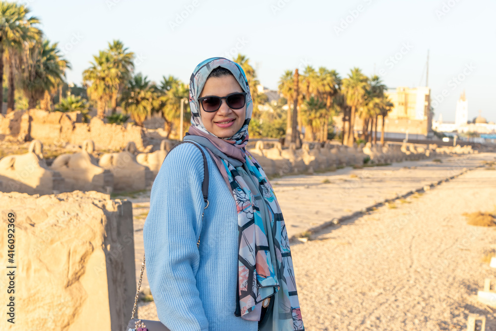 cute young woman tourist in the Karnak temple of Luxor, Egypt. this was the largest temple complex of Amun-Ra god in ancient Thebes town
