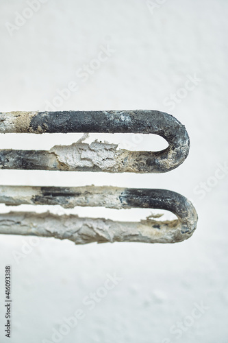 faulty washing machine heater. place and scale on the heating element. close-up
