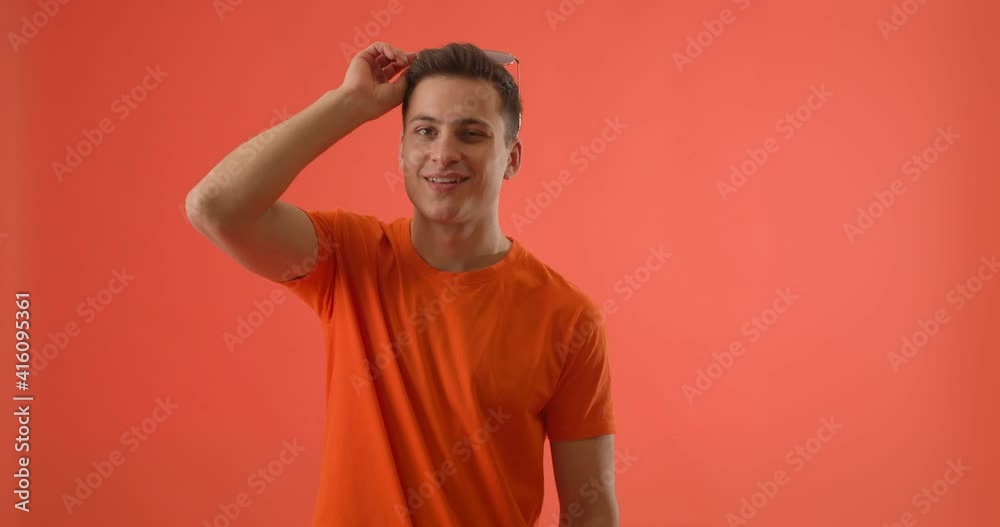Cool young man with mobile phone on color background Cool young man with mobile phone on color background