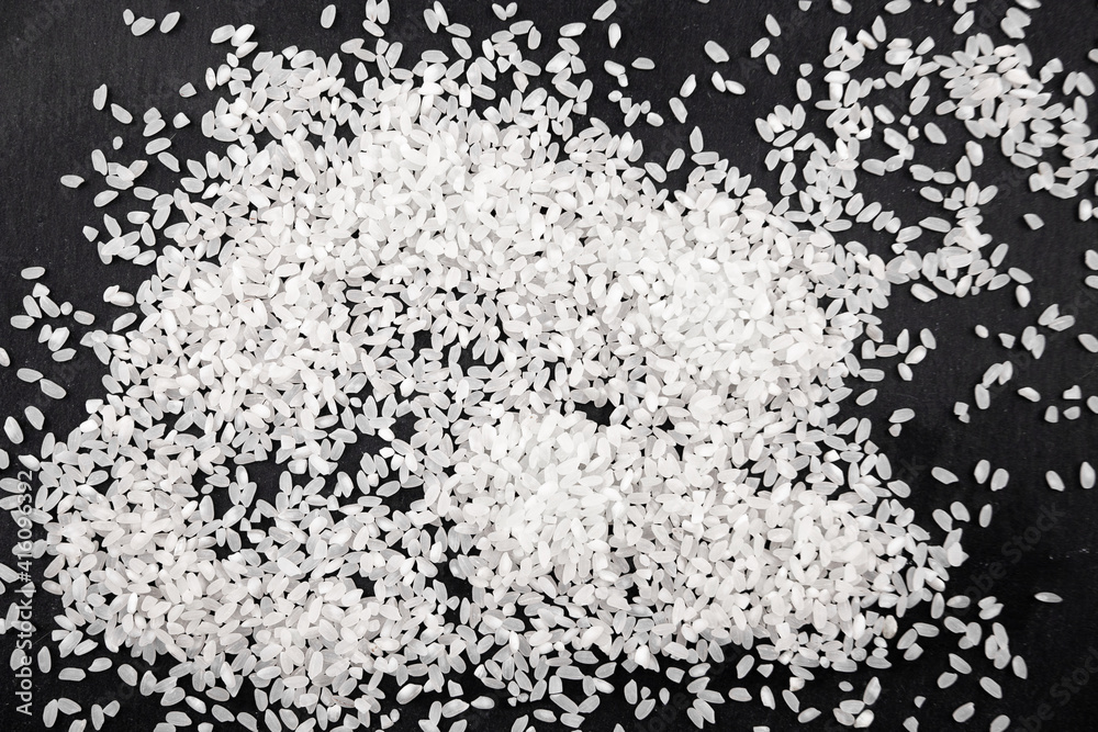 Rice with scattered on the table. Rice on the background. Rice with scattered on the table. Rice on the background.