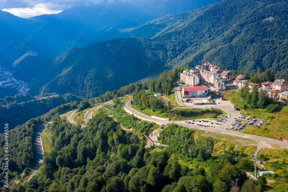 Summer aerial view of the Ski Resort Rosa Khutor. A complex of hotels on the site of the former Olympic village of Rosa Plateau at an altitude of 1170 m from sea level. Krasnaya Polyana, Sochi, Russia