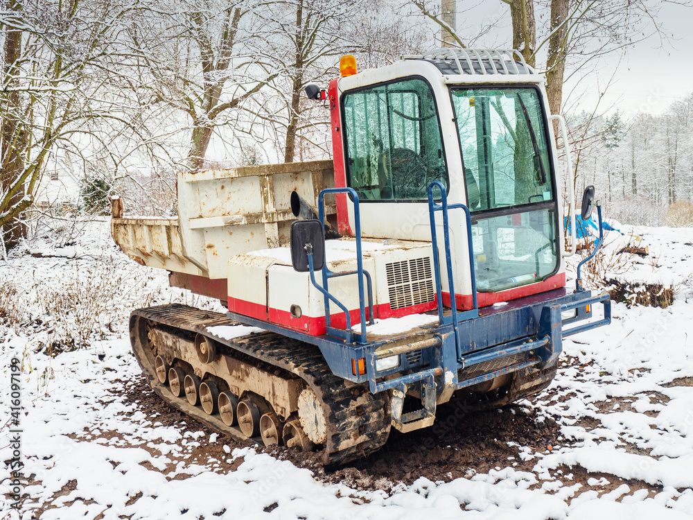 Small Dumper Tracked Truck with Muddy Chassis. The transporter waiting