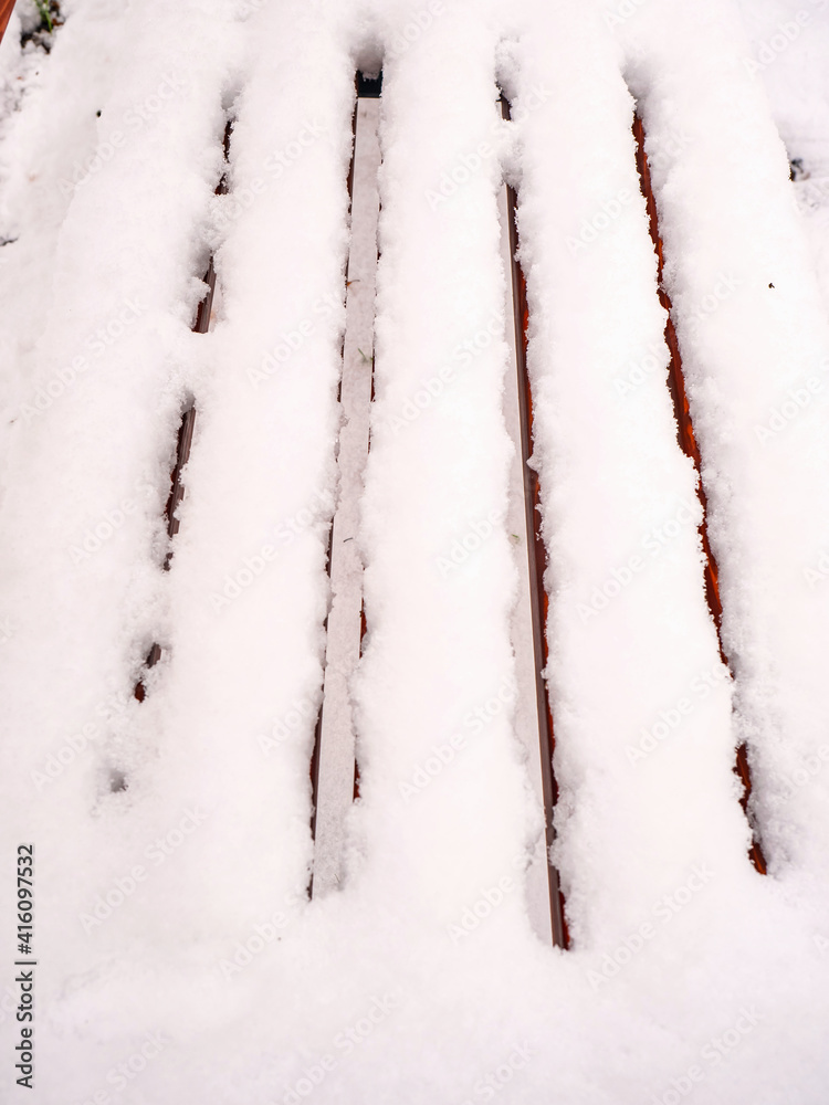 Fresh powder snow covered the bench seat