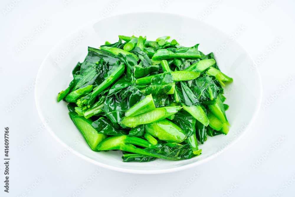 A dish of fried kale on white background A dish of fried kale on white background
