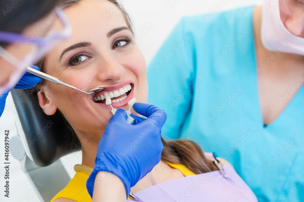 Woman discussing dental bleaching with her dentist Woman discussing dental bleaching with her dentist