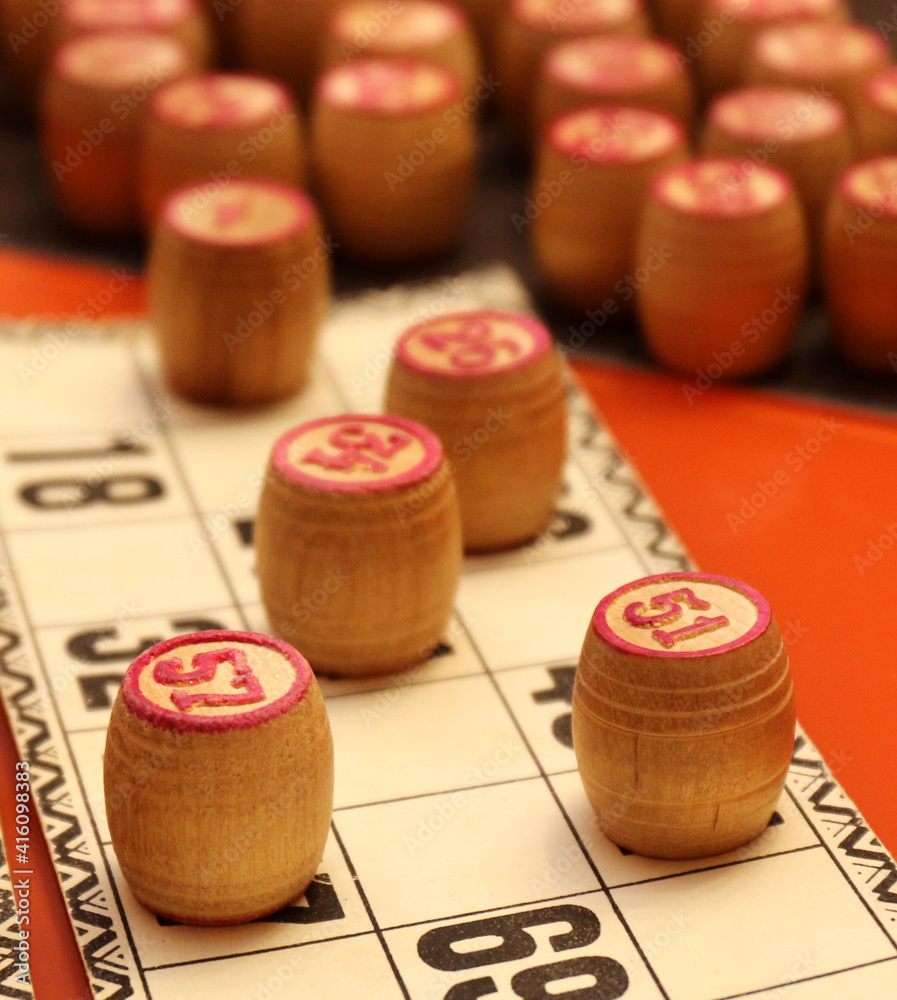 Lotto board game. Wooden lotto barrels and cards. Bingo game. Gambling Lotto board game. Wooden lotto barrels and cards. Bingo game. Gambling