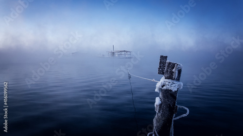 Winter morning at the Reftinsky reservoir with fishing houses on the water, Russia, Ural in February photo